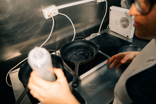 Cooking Food in a Kitchen With Cast Iron Pans and an Electric Stove
