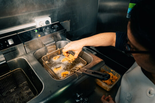 Cooking Food in a Deep Fryer at a Restaurant During the Day
