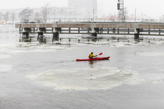 Profile View of Kayaker Paddling in Misty Scandinavian Harbor