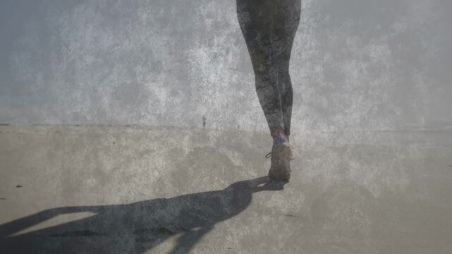 Woman runner pushing off sand, gaining steady beach pace for health, showing shoes and overlays