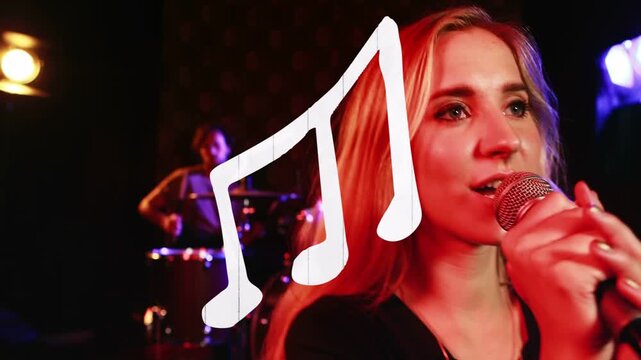 Camera cutting close, singer gripping mic, singing, smiling, drummer keeping beat to perform