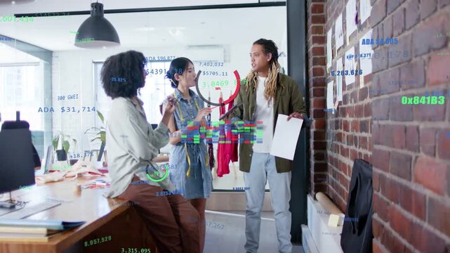 Middle woman raising red garment, team gesturing and reviewing sample metrics for design review