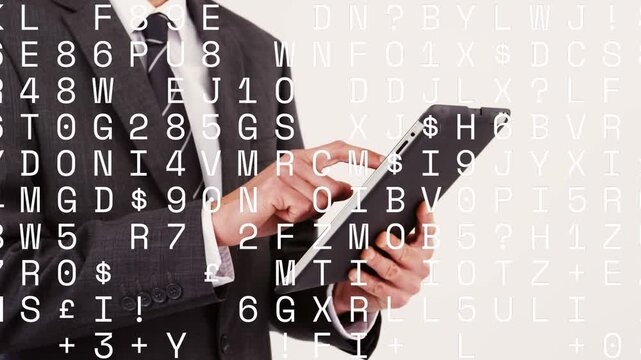 Male business exec tapping tablet, reviewing data with text overlay drifting over hands