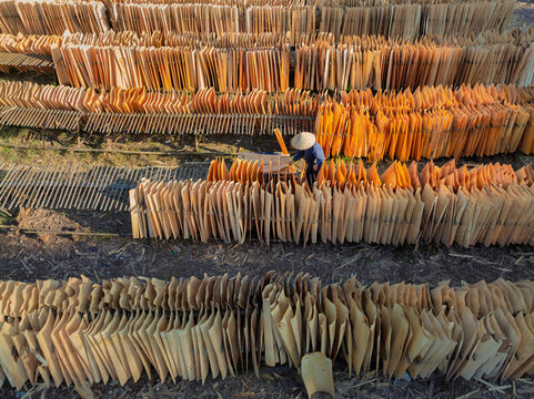 Worker Among Bamboo Slats