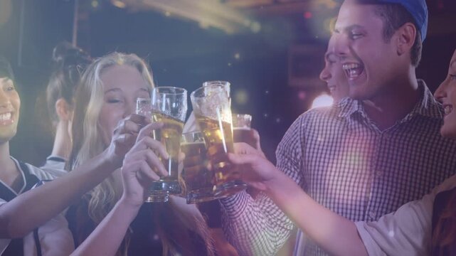 Friends raising pints in dim bar, man reaching initiating clinking, lens flares overlaying toast
