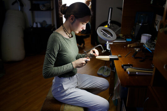 a woman makes jewelry
