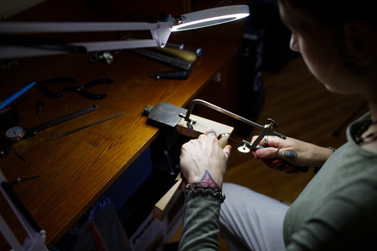 a woman makes jewelry