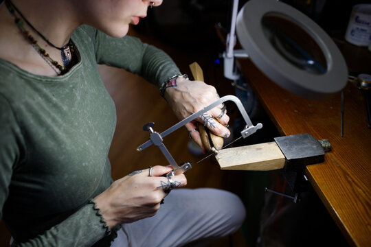 a woman makes jewelry