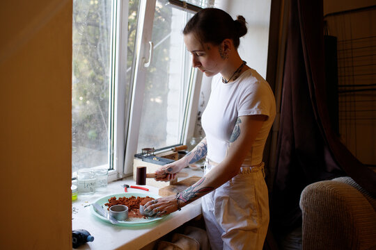 a woman makes jewelry