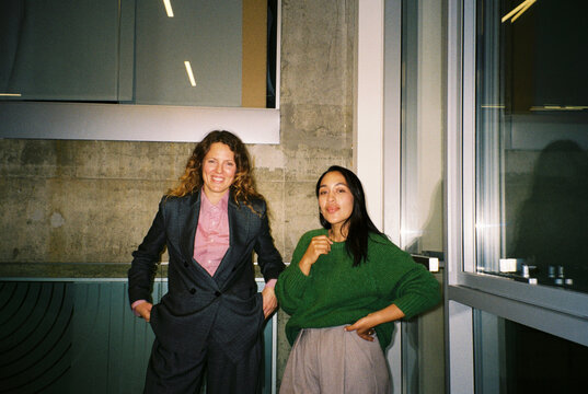 Two businesswomen smiling at the camera