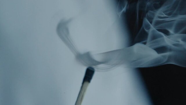 Macro shot of a match being lit through friction with the striking surface 