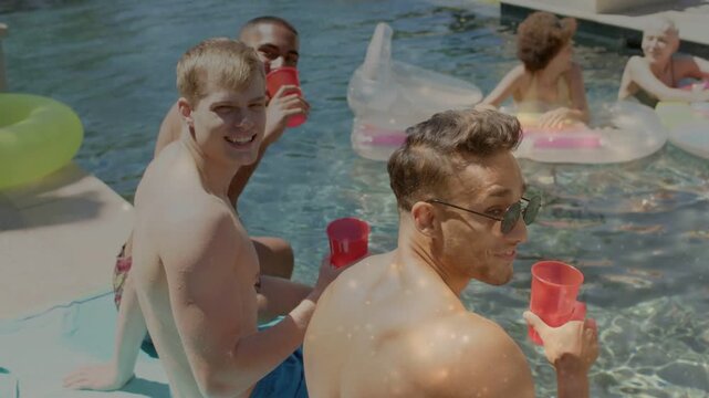 Trio responding to camera call poolside, clinking red cups, animated likes rising for social media