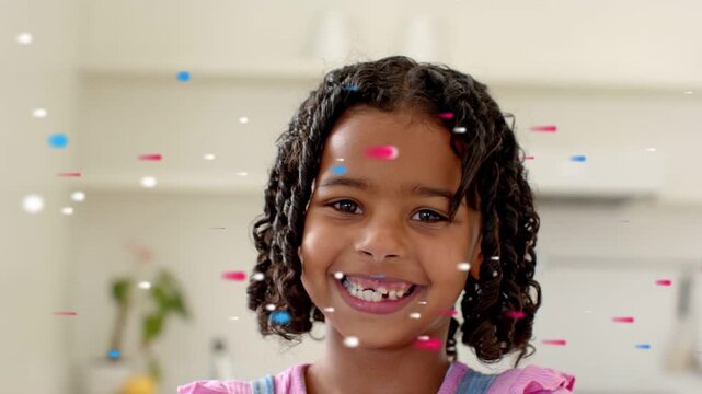 Girl smiling and beaming showing front tooth gap with confetti overlay sparking smile for education