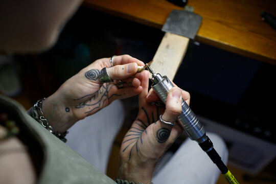 a woman makes jewelry