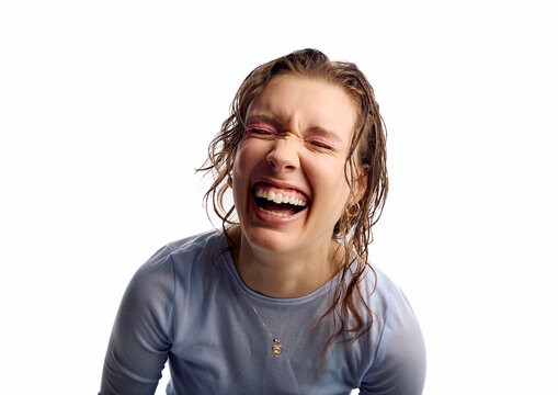 Happy woman laughs at the camera
