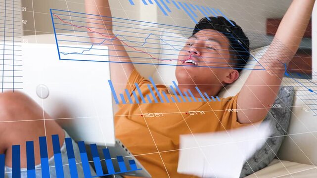 Man opening report on sofa, reviewing charts, flipping pages while animated finance graphs shifting