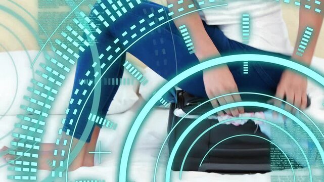 Woman sitting on bed opening suitcase, pulling garments, tucking, zipping, teal HUD showing travel