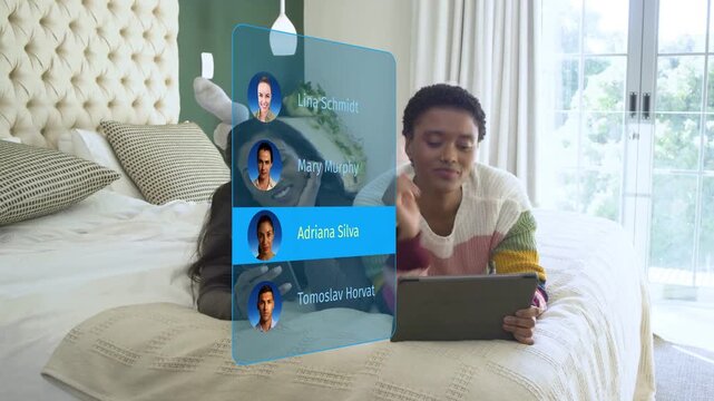 Two women reclining bed tapping tablet cycling tech holo contacts phone ending on Mary to call