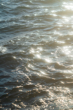 Sunlight sparkles on gentle ocean waves 