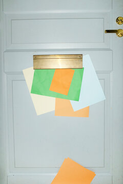 Door with mailbox and lots of colourful letters and mails with flash