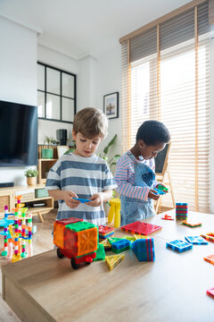 Diverse children playing with educational crafts in school