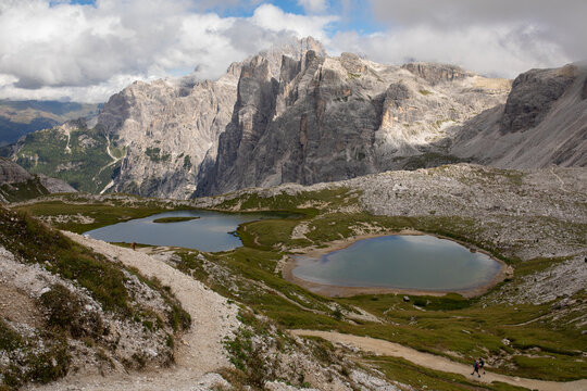 Hikers Explore Alpine Lakes in the Dolomites Mountains in Summer