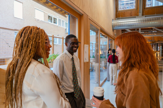 Colleagues chatting in a modern office environment