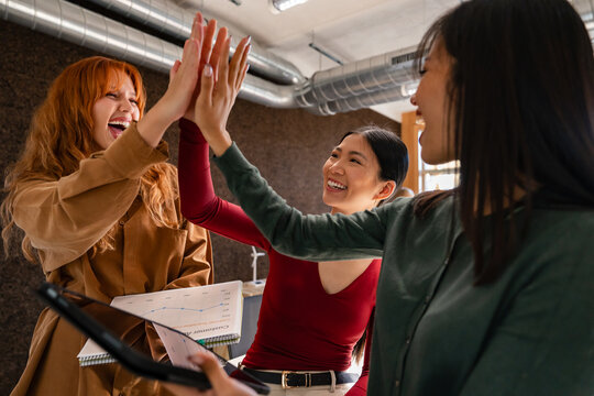 Diverse team celebrating success with a high five