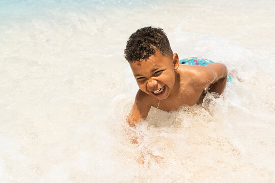 Young child caching waves at the beach