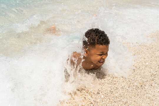 Young child caching waves at the beach
