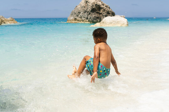Young child caching waves at the beach