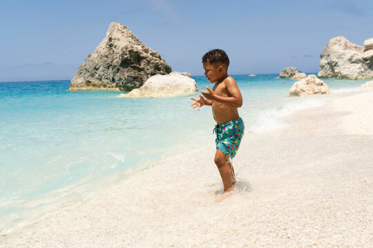 Young child caching waves at the beach