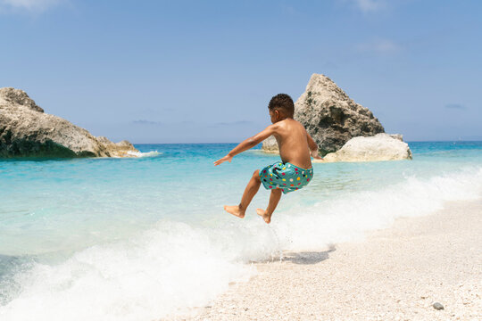Young child caching waves at the beach