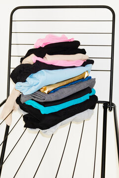 Colourful laundry clothes on a drying rack with direct flashlight