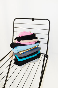 Colourful laundry clothes on a drying rack with direct flashlight