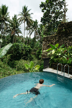 Relaxing Swim in a Tropical Paradise Surrounded by Lush Greenery
