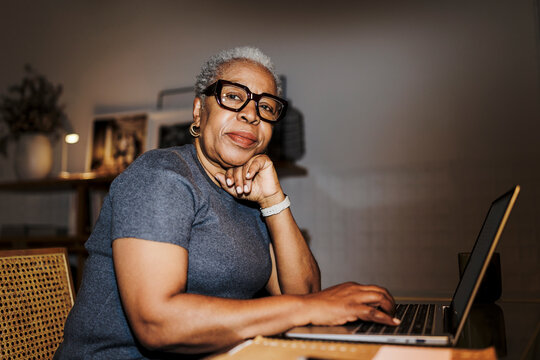 Senior woman working remotely with laptop at home