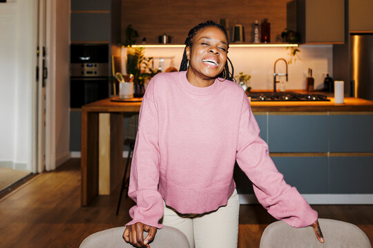 Woman laughing enjoying casual moment in kitchen ugc