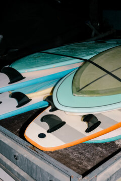 Flash lit shot of surfboards piled up and tied to a wooden base