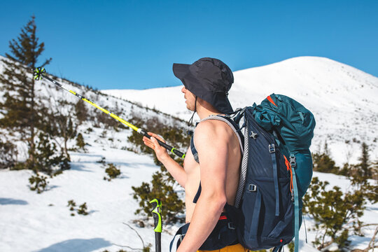 Freeride skiing in remote backcountry mountains under clear winter sky