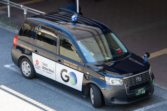 NERIMA, TOKYO, JAPAN - APRIL 8, 2026: A taxi vehicle wrapped with advertisements for the GO taxi app operates near Nerima Station in the Nerima district of Tokyo.