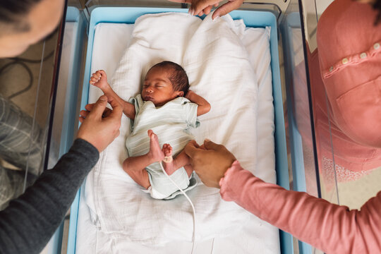 Newborn baby getting care from parents in hospital