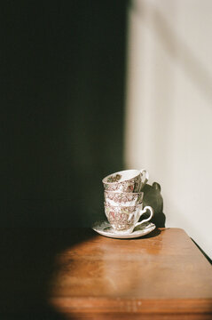 Vintage Teacups in Dramatic Sunlight