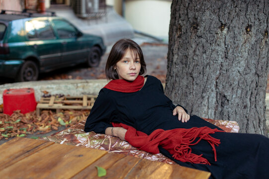portrait of a young woman in a red scarf