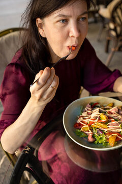 A girl is eating in a cafe