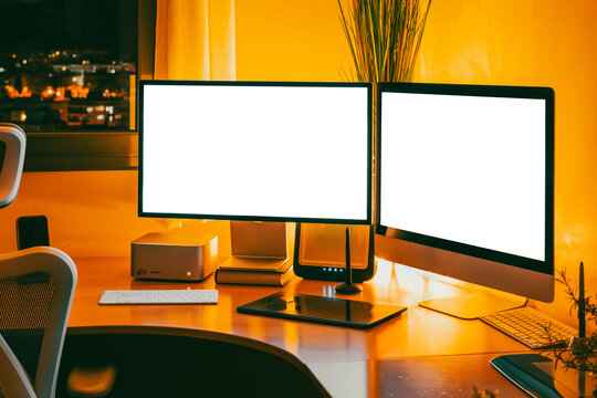 Work studio at night with computer and desk setup