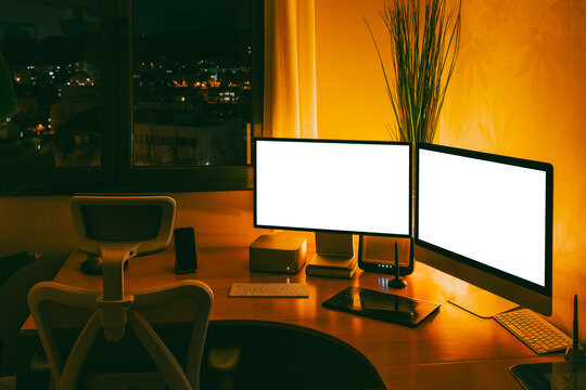 Work studio at night with computer and desk setup