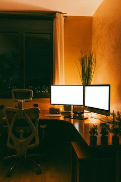 Work studio at night with computer and desk setup