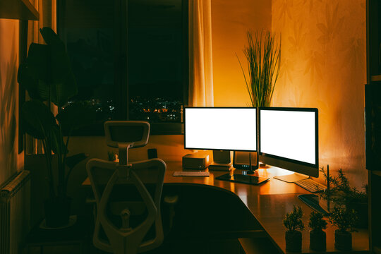 Work studio at night with computer and desk setup
