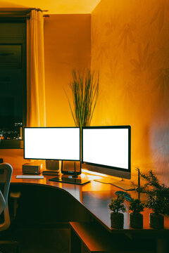 Work studio at night with computer and desk setup